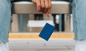 a person holding a blue credit card