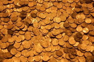 A pile of copper pennies scattered together in a close-up view.